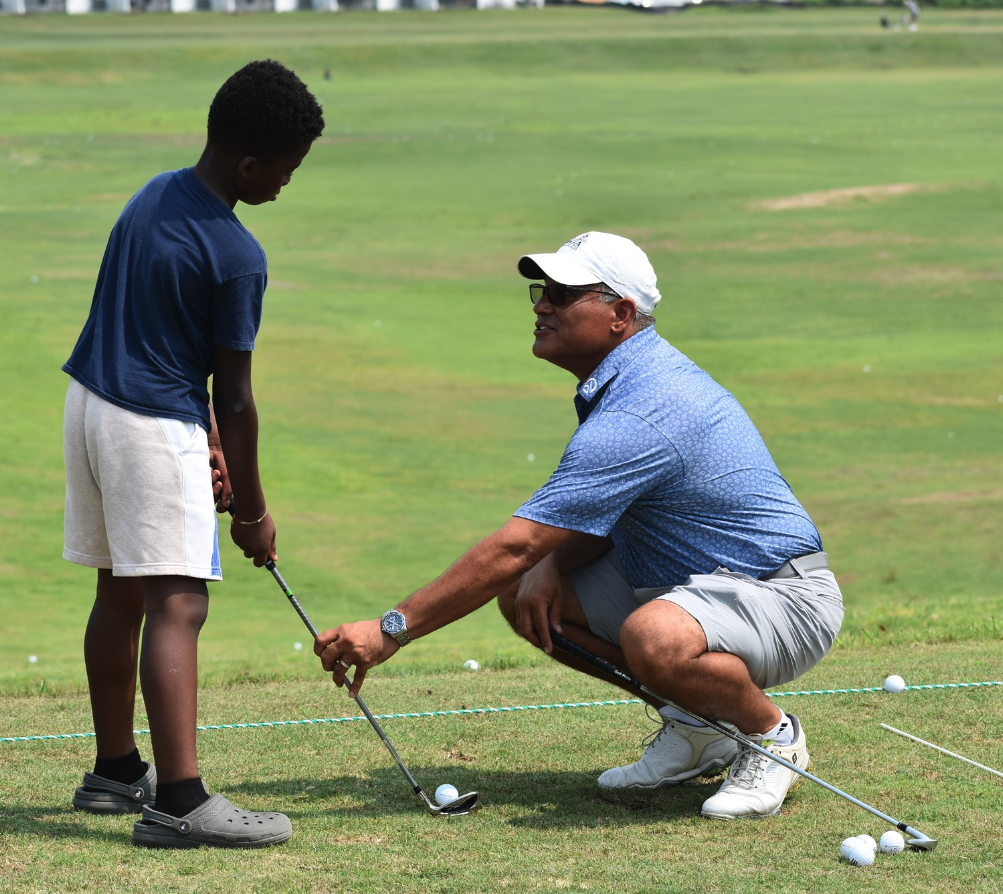 Golf instructor helping youth